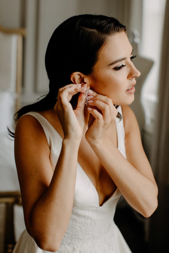 Bride putting the finishing touches on her wedding day look