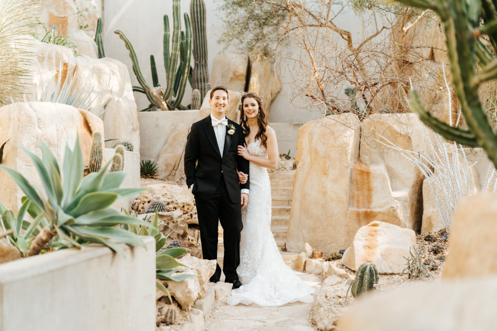 Bride and Groom posing for a photo in the San Antonio Botanical Gardens desert exhibit