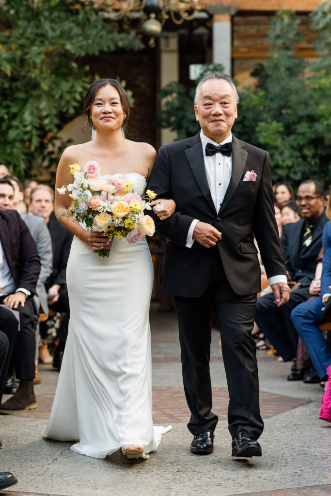 Dad walking bride down the aisle at her Valentine DTLA oasis wedding ceremony