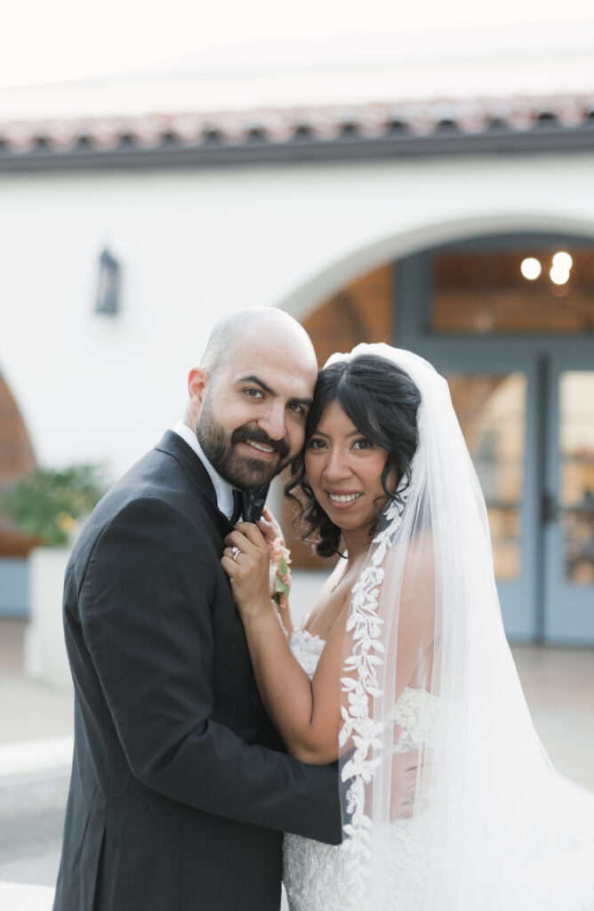 Posed photo of the newlyweds debunking the wedding planning myth that everything will go perfectly.